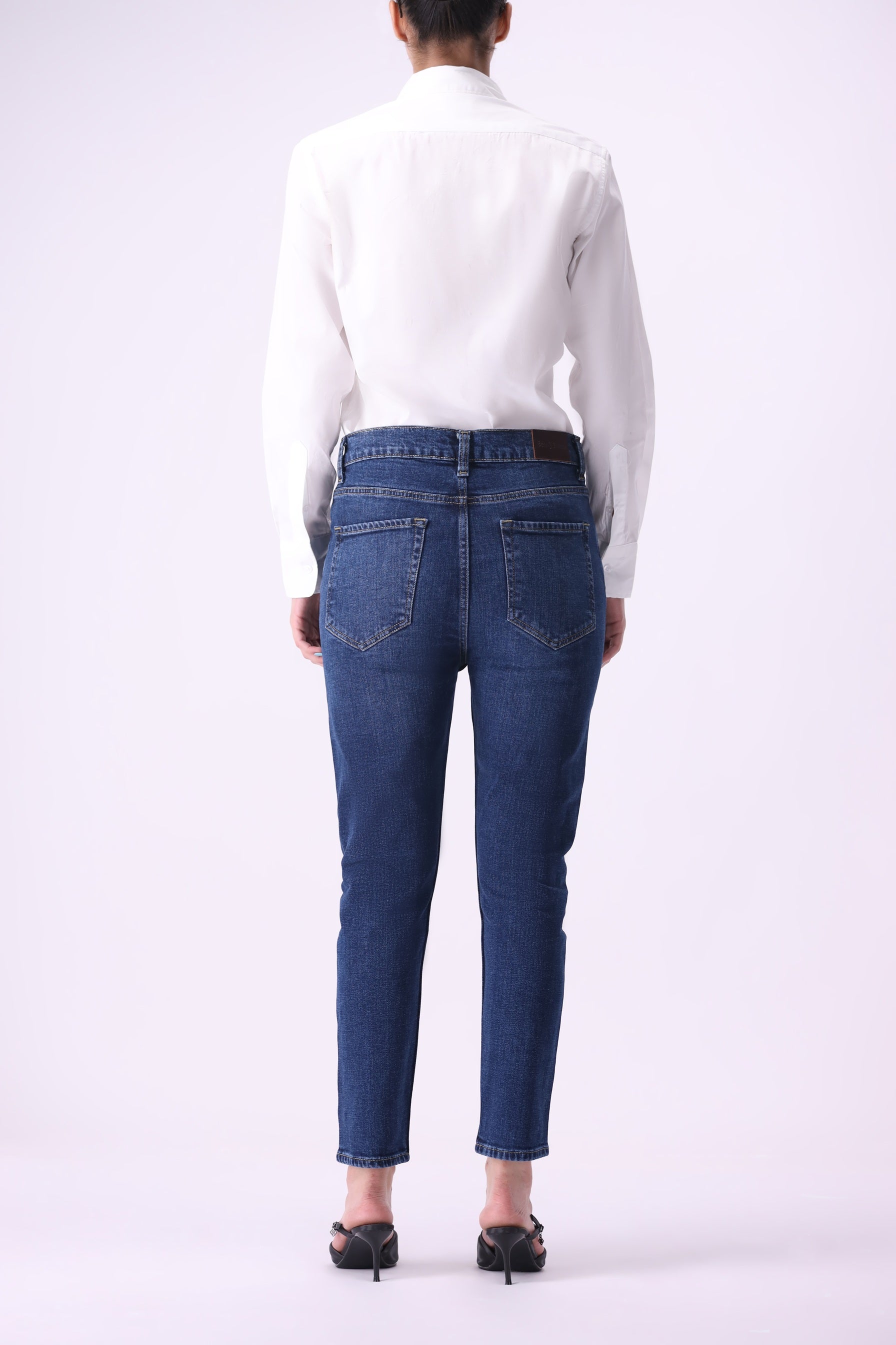 Back view of women’s Shirikaba high-rise boyfriend jeans in dark indigo denim with 25% stretch.