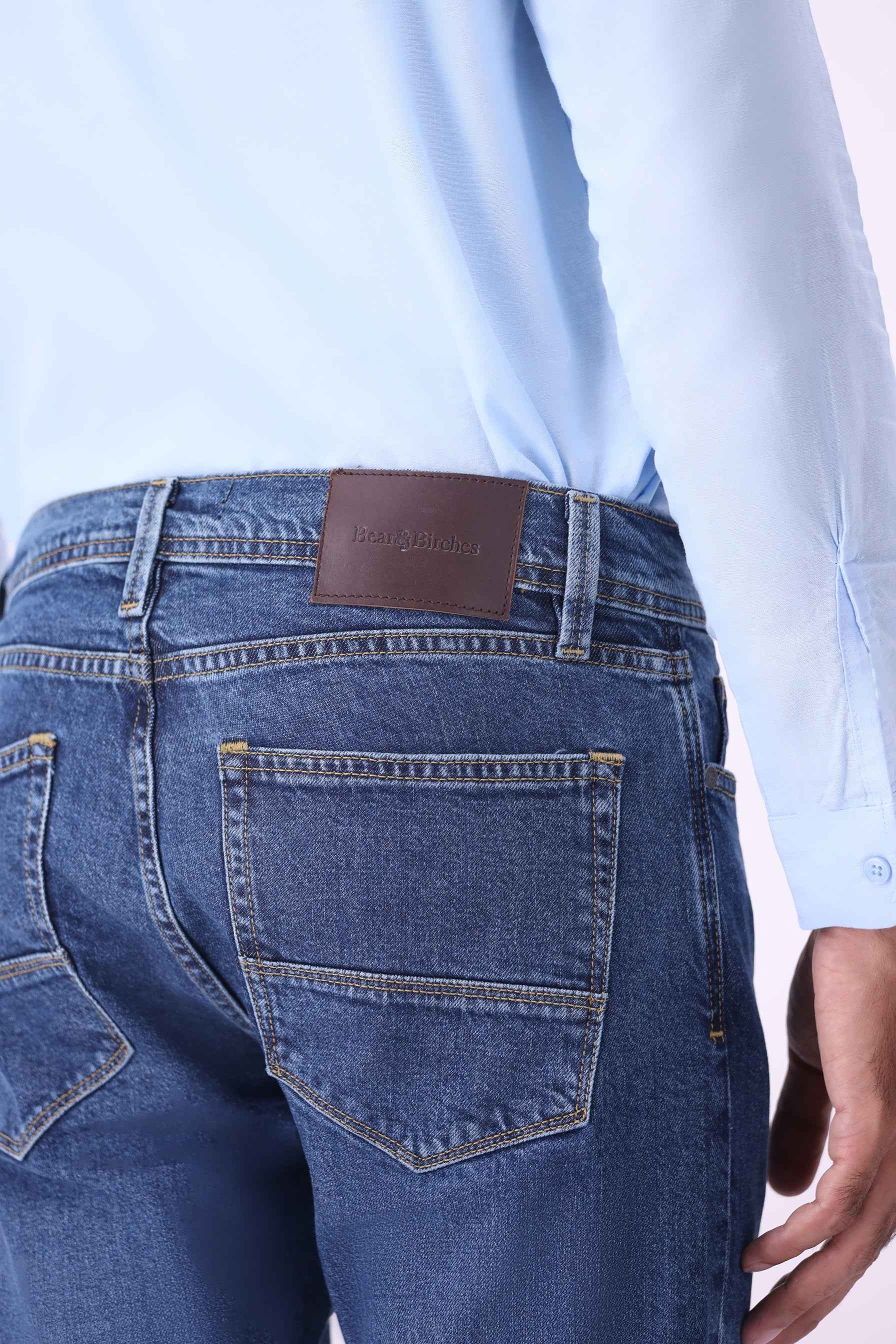 Back view of Baloo tapered jeans featuring classic pocket styling and a signature Bear & Birches leather patch.