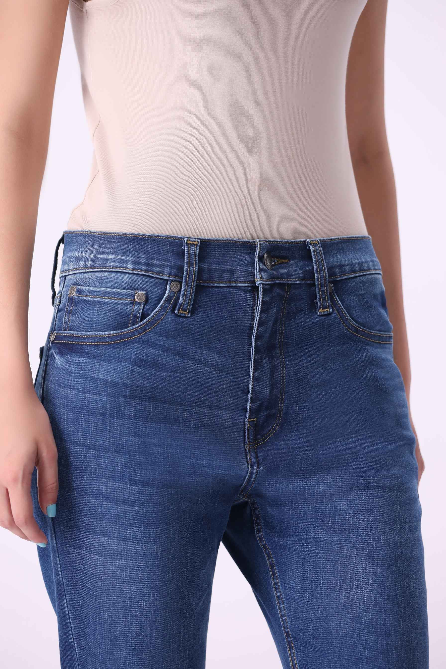 Close-up front view of Canoe flare jeans highlighting the high-quality sustainable denim and flattering high-rise fit.