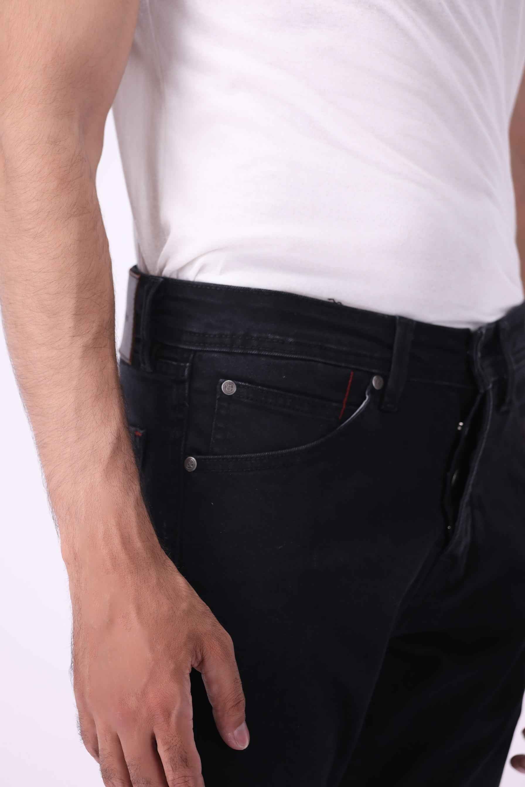 Close-up front view of Gom black jeans showing the durable high-quality denim texture and secure waistband.