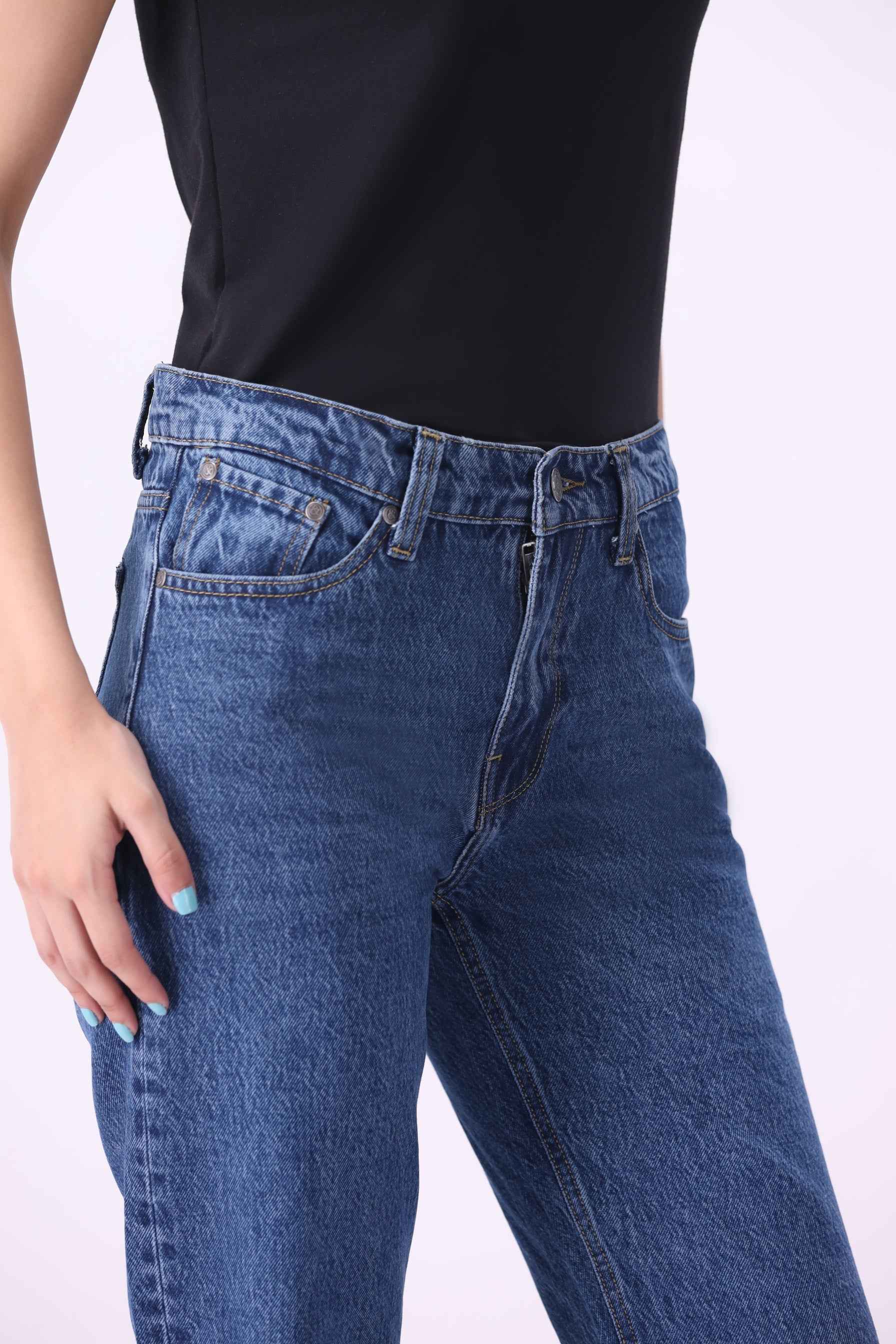 Close-up front view of Koivu jeans highlighting the high-quality sustainable denim texture and supportive tapered fit.