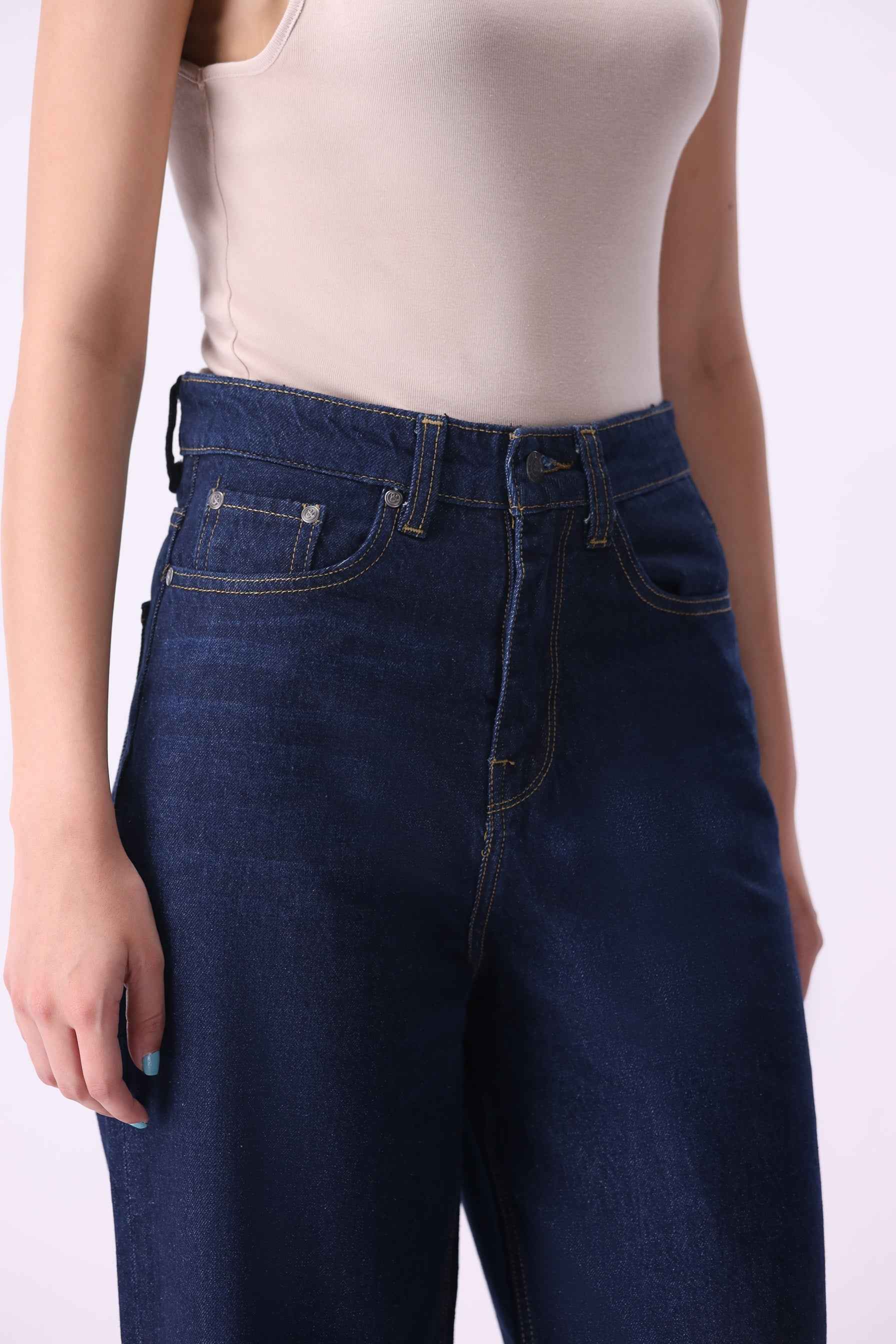 Noor wide-leg jeans in a premium mid-indigo wash, featuring sustainable organic and recycled cotton.