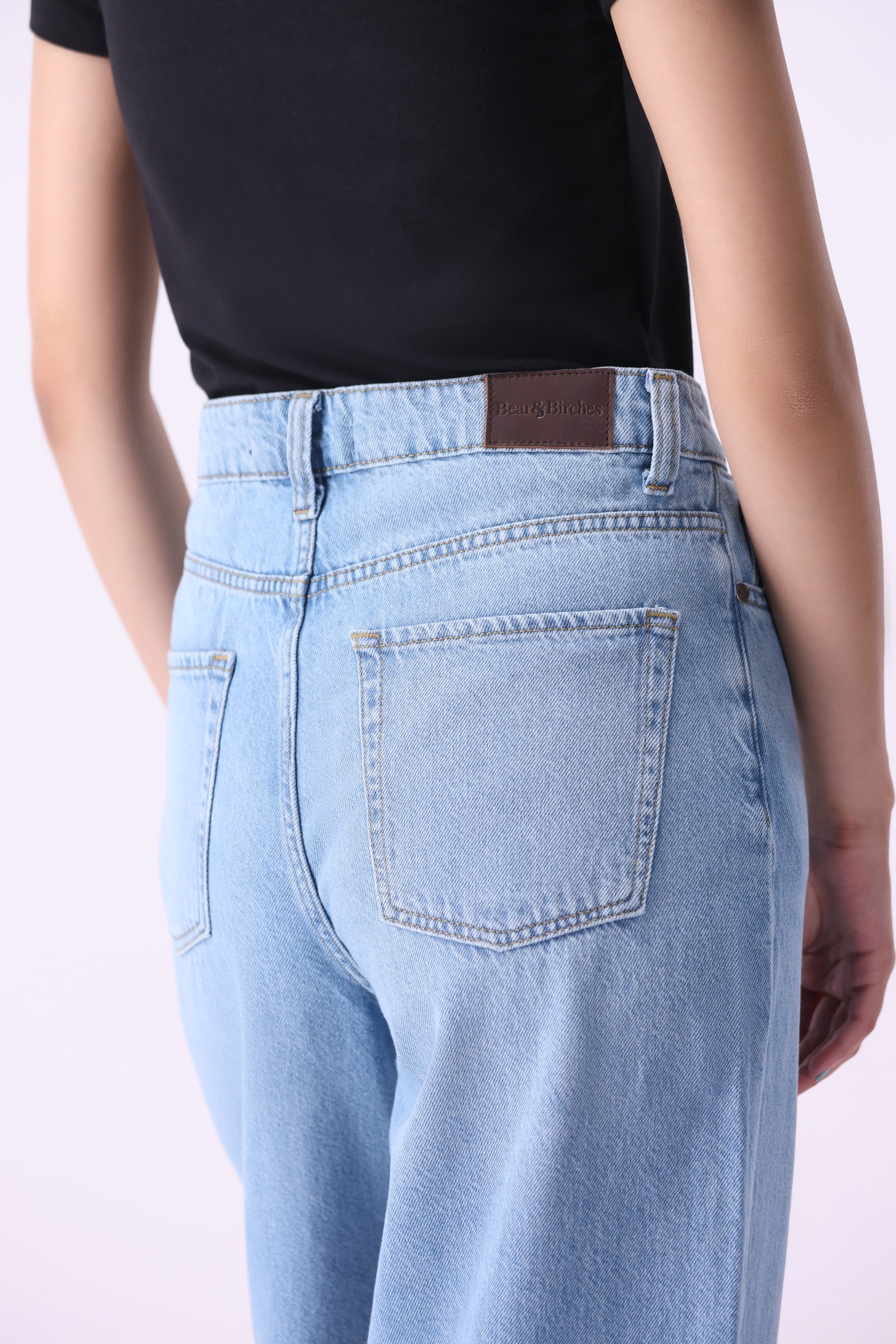 Light wash wide-leg jeans back close-up leather patch – Noor sustainable denim by Bear & Birches denim