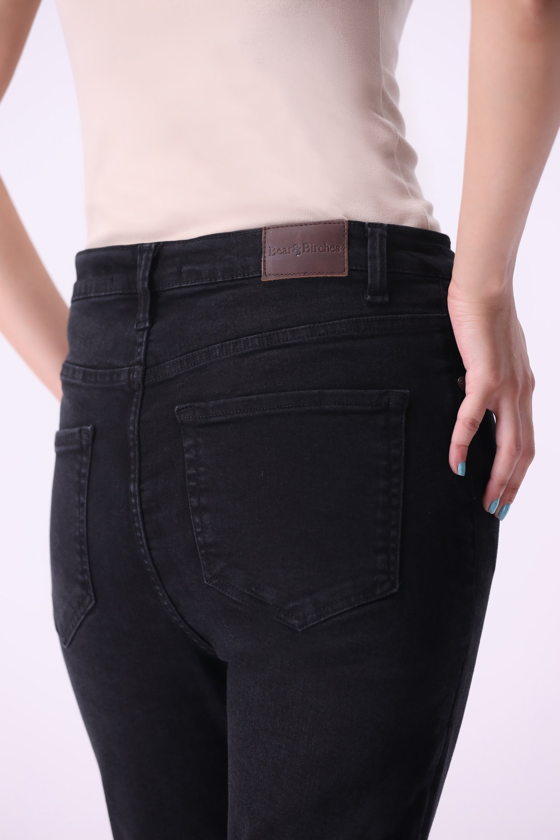 Back view close-up of women’s Beryoza jeans in black wash with visible leather patch.