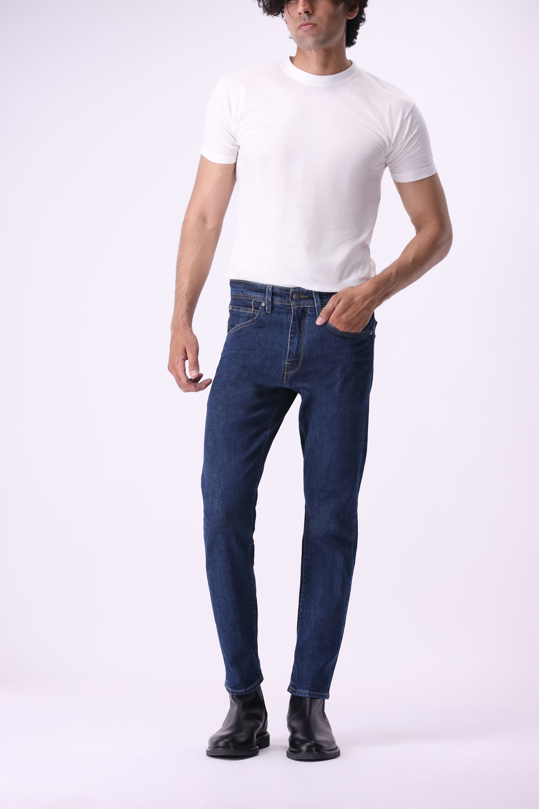 Front angled view of Bear & Birches Ursa men’s jeans in dark blue wash, styled with white t-shirt