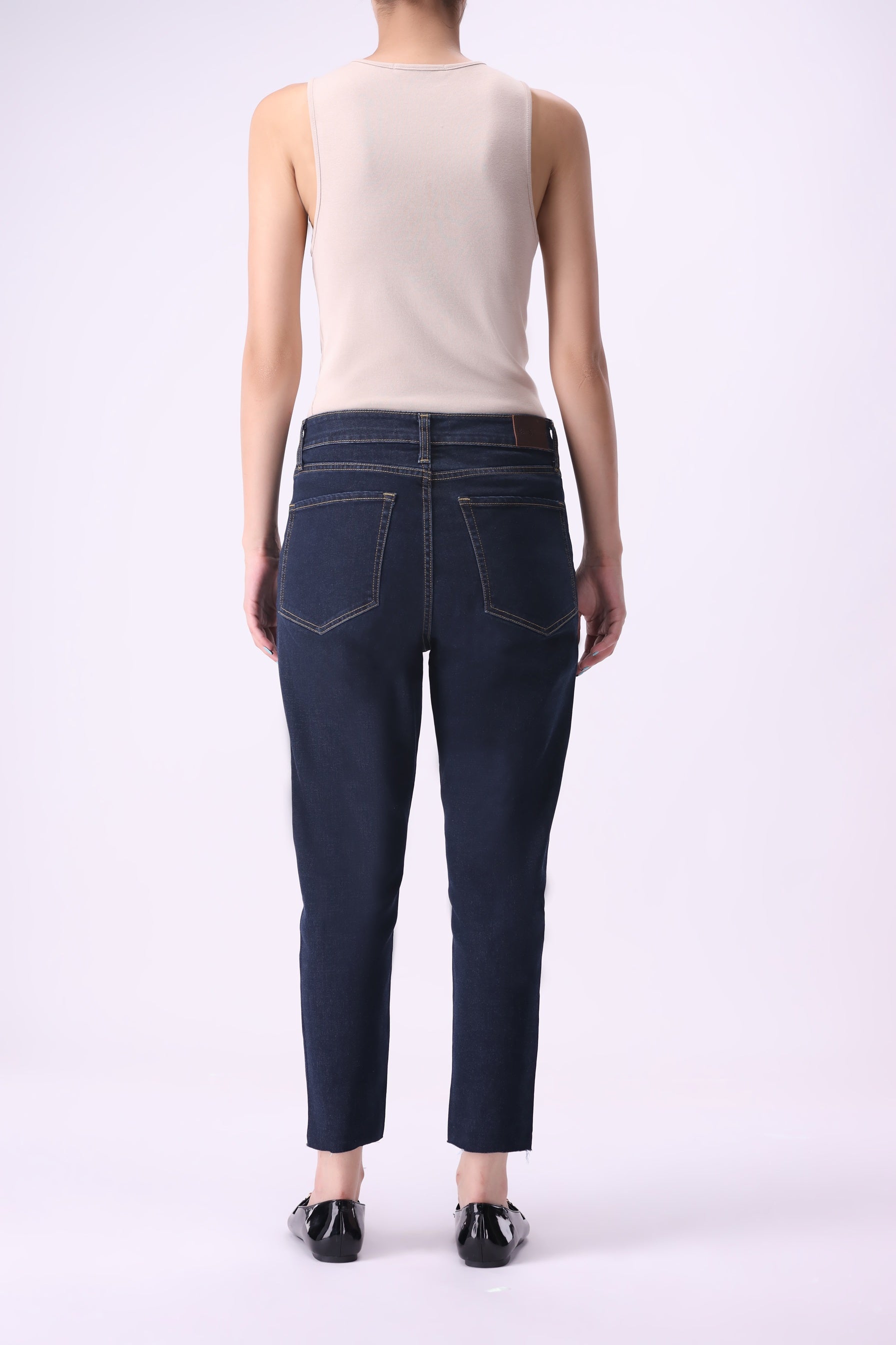 Back view of Bear & Birches Birke women’s tapered high-rise ankle jeans in dark indigo wash