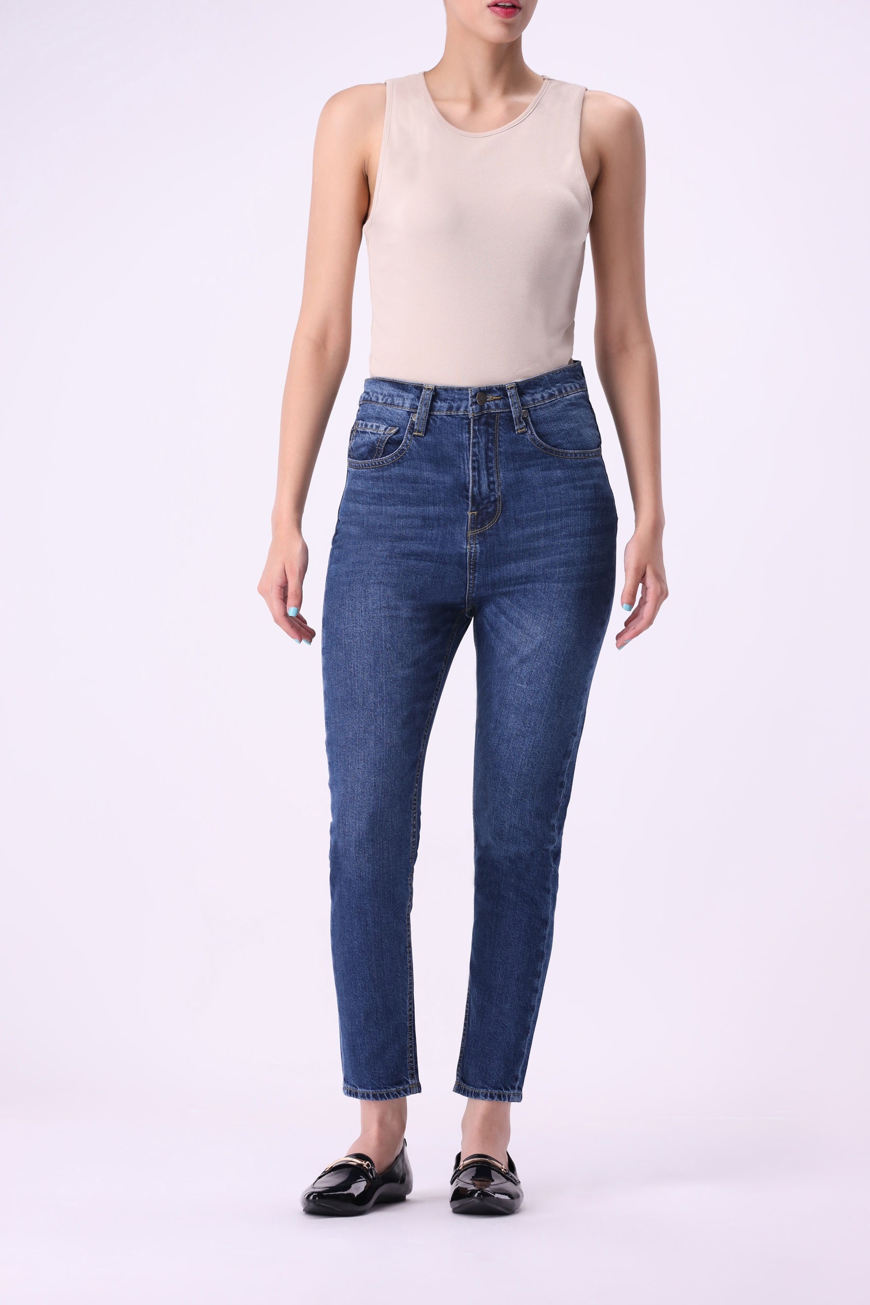 Front view of women’s ankle-length skinny jeans in dark indigo denim, high-rise fit