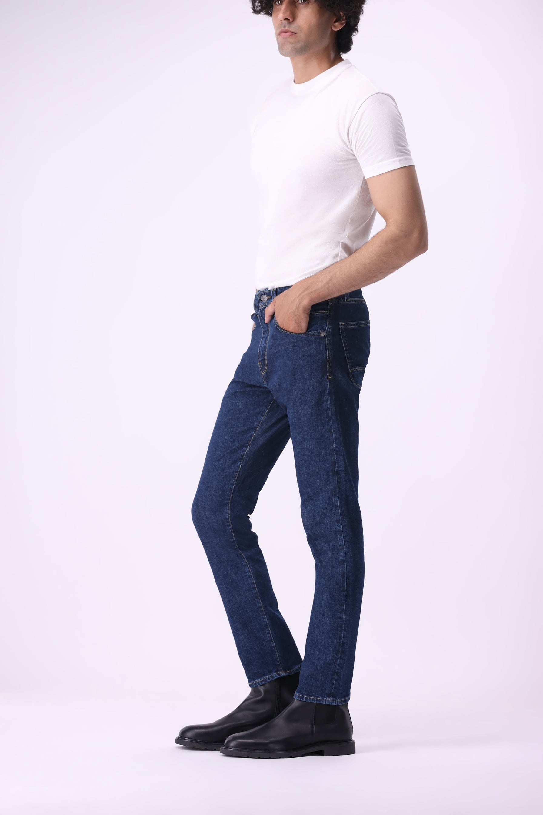 Side view of Bear & Birches Ursa men’s jeans in dark blue wash, styled with white t-shirt