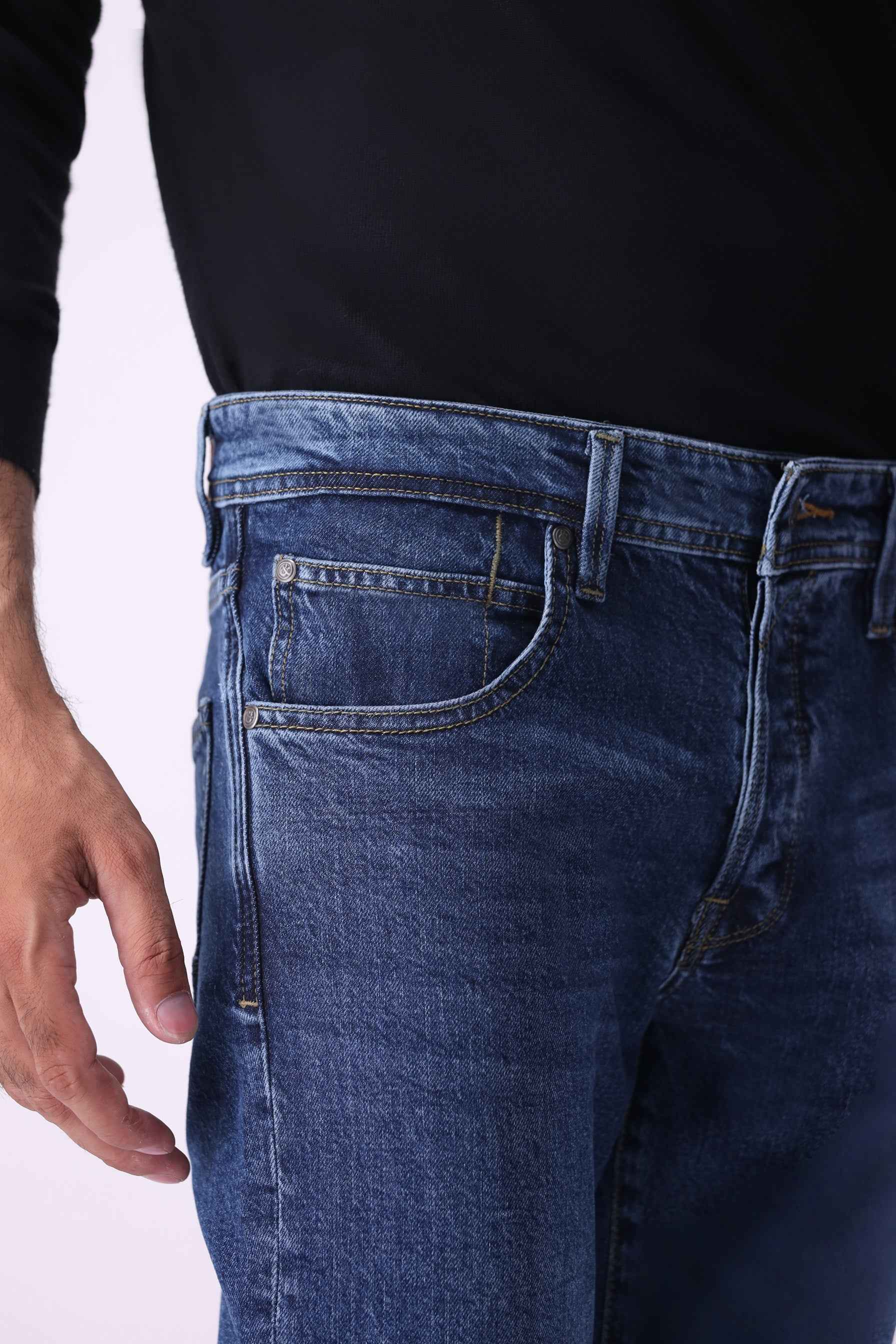 Close-up front view of Benji indigo jeans highlighting the durable high-quality denim texture and secure waistband.